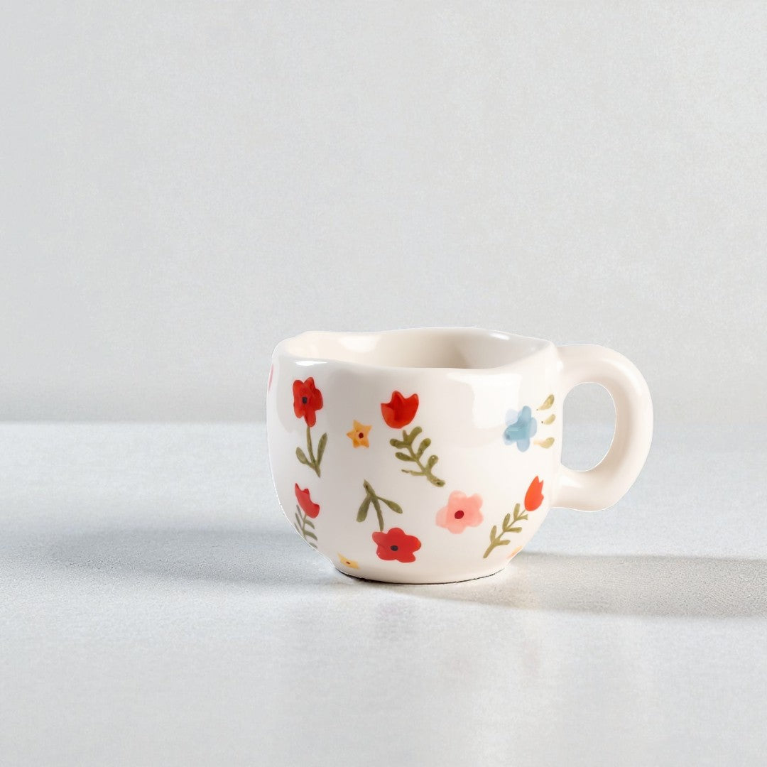 White mug with colorful floral pattern on a light gray background