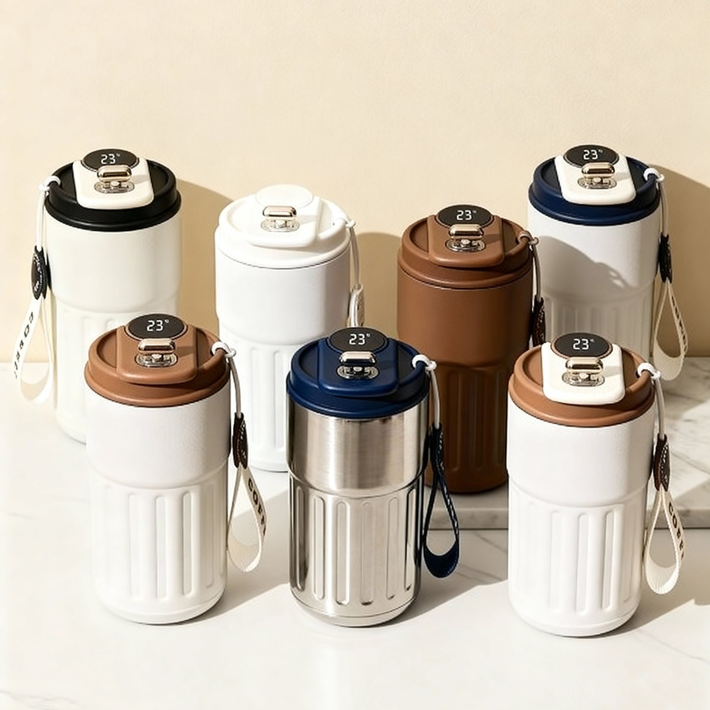 Set of stainless steel insulated mugs by Lunari Haus with assorted neutral-toned lids on a soft beige background in warm natural light.